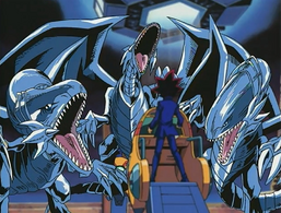 Yugi facing 3 "Blue-Eyes White Dragons"