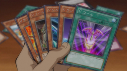 Yuma holding several "V" cards.